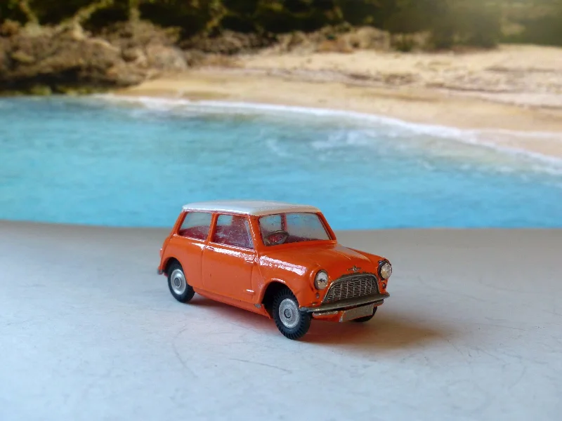 N - Scale Model Train Layout with a City - Themed Background and Animated Figures227 Morris Mini-Cooper in orange with red interior (rebuilt)